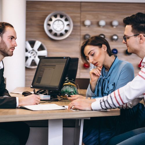 Family buying a car at a dealer